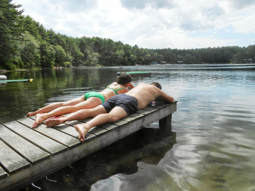 swimmers relax on dock in Myles Standish State Forest